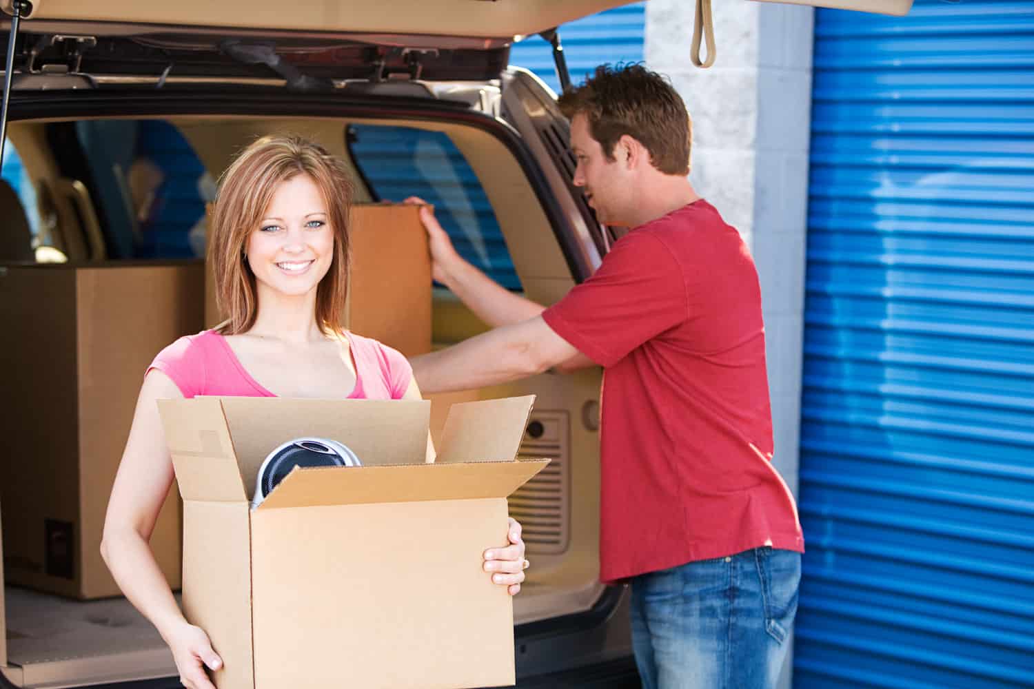 Couple loading boxes at an All Island Storage unit